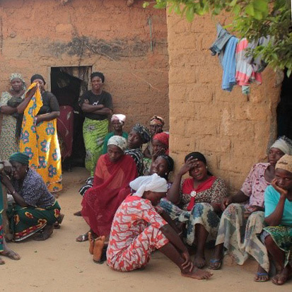 Families in the village weep over their losses.