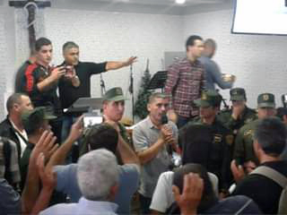 Special police forces (in green) remove worshippers from an Algerian church.