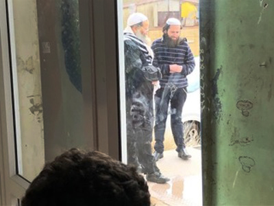 Members of the radical group stand outside the church. Credit: Middle East Concern.