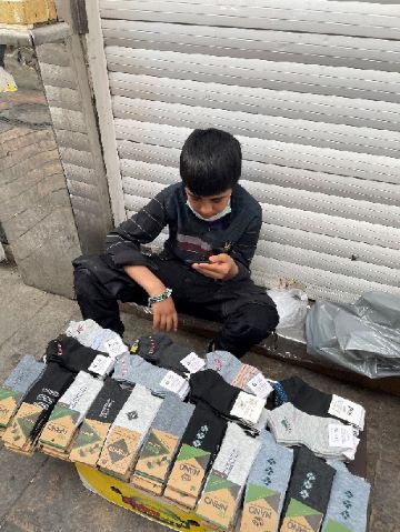 Gospel workers shared Christian materials with this boy selling socks in an Iranian marketplace.