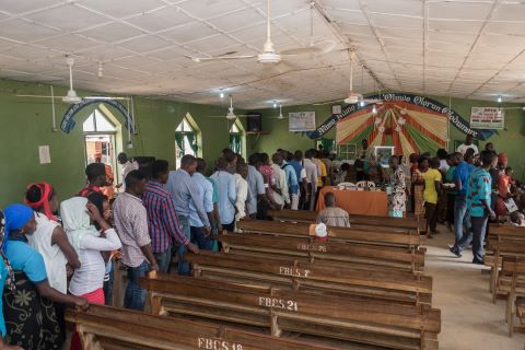 Islamists armed with guns attacked a Christian worship service, killing one and abducting three others.