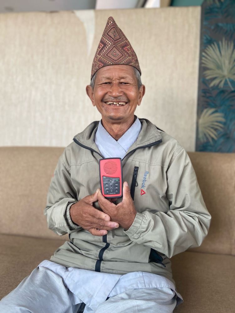 A joyful Gambir Behadur Rai with his audio Bible.