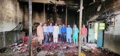 Pakastani Christians stand amid the rubble of a church destroyed by a mob of Muslims.