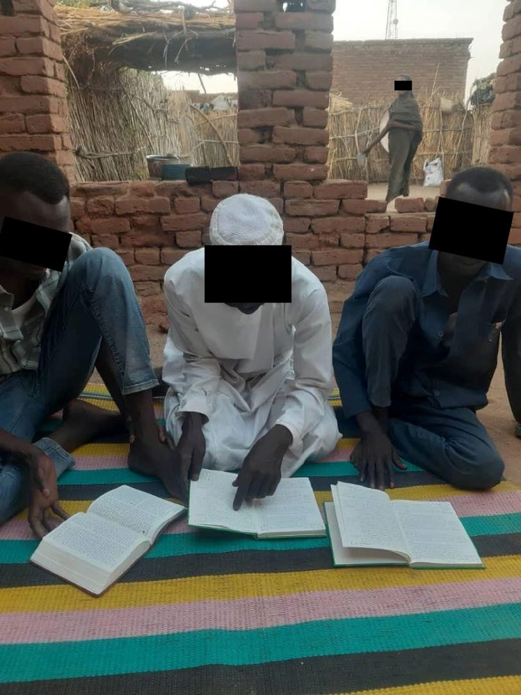 Musa (the man in the middle) studies the Bible with Saad and a local pastor.