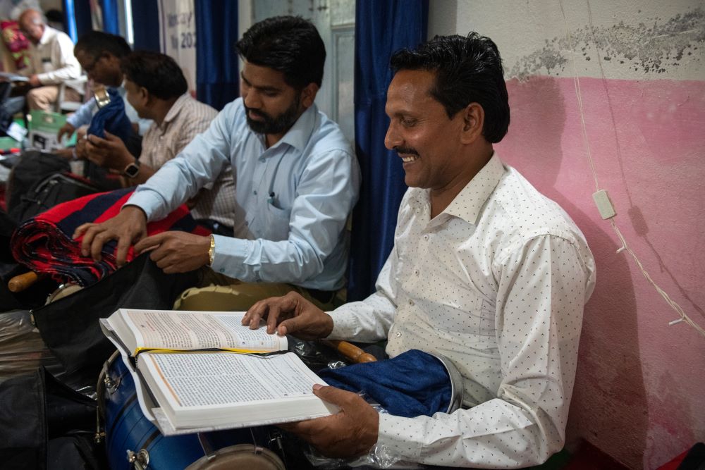 Front-line workers joyfully open Village Outreach kits that contain study Bibles, flashlights, instruments, raincoats and other items to help and encourage them in their ministry.