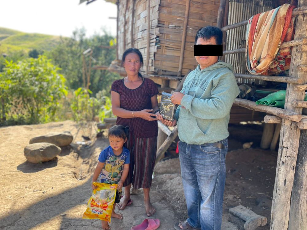 Vanh received a new Bible after her first one was stolen from her hut.