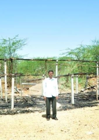 Pastor Ruben stands in front of "The Church of South India" which was burned down on March 18.